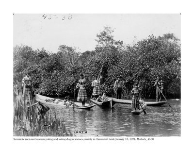 Seminole men and women poling and sailing dugout canoes on Tamiami Canal, 18 January, 1921 by Claude C. Matlack